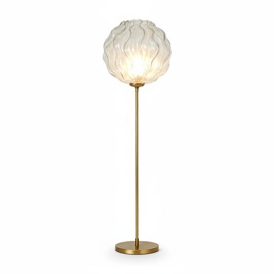 Gold-tone ripple glass globe floor lamp on a white background