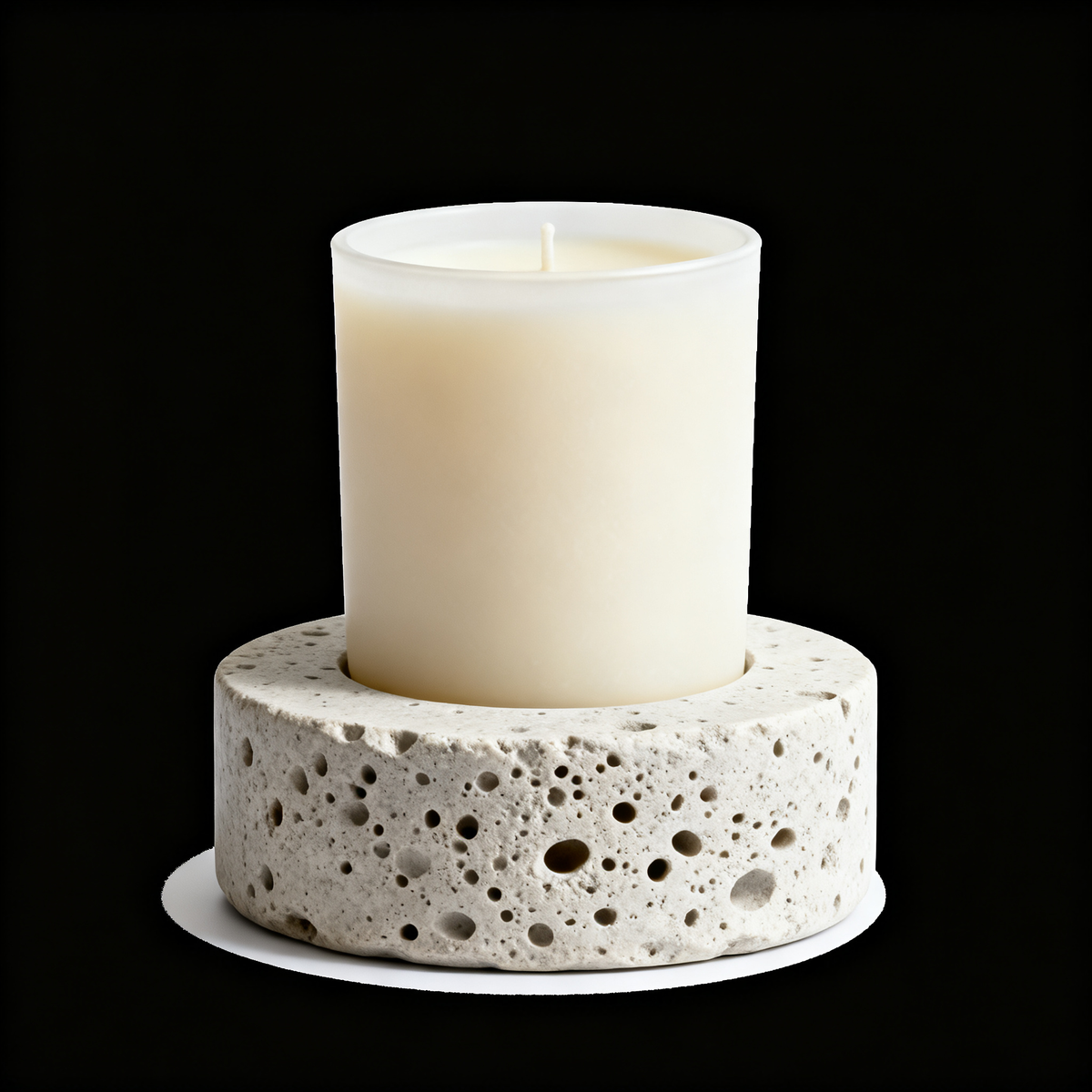 Original product image of a porous white stone candle holder with cream pillar candle