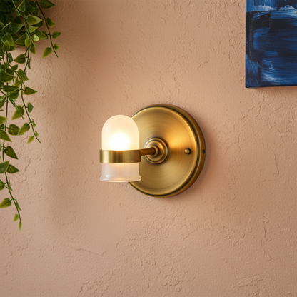 Close-up of the Halo brass wall plate, arm, ring holder, and frosted glass shade