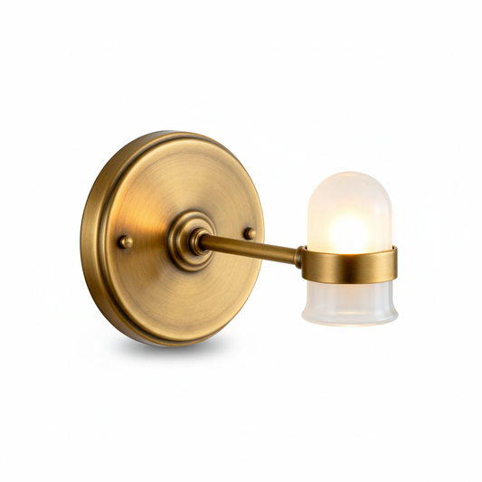 Halo antique brass wall sconce with frosted cylindrical glass shade on a white background